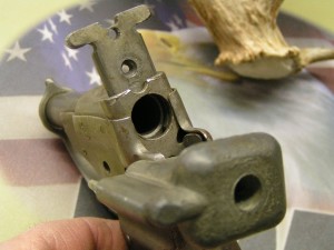 This image shows how the back of the Liberator pivots open to load a single .45ACP round.  Once fired, the breech is pivoted again and the provided wooden dowel is pushed down the barrel from the muzzle to push the empty case out.