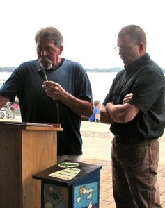 (Photo by Steve Weisman) Greg Drees (L) introduces Steve Anderson as the 2015 Ace Cory Conservation award winner at the Okoboji Protective Association’s annual meeting held during the Clean Water Concert activities.