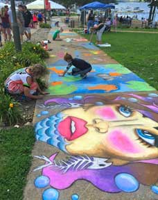 Adults and kids enjoyed decorating the drab sidewalks with colorful artwork. 