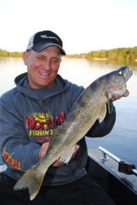 (photo by Bob Jensen) Mike Frisch with a skinny walleye that was looking for food to fatten up. Find the food, find the fish.