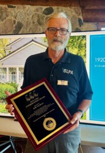 Joe Ulman holds the Ace Cory Conservation Award plaque awarded at the Okoboji Protective Association’s annual meeting.